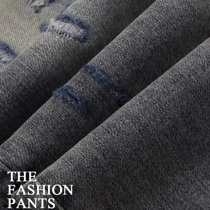Men's washed-out slim fit jeans with patch detailing and embroidered branding on micro-elastic cotton