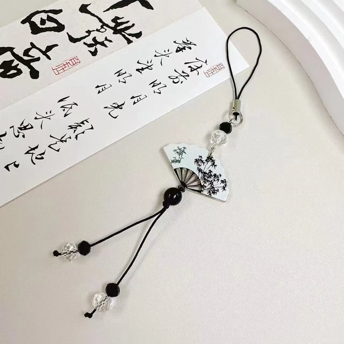 Chinese style bead pendant keychain with floral patterns in baked varnish finish