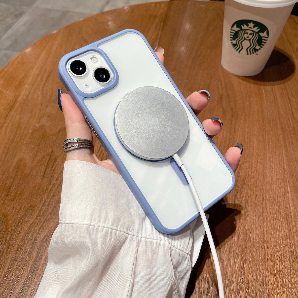 Transparent acrylic MagSafe phone case for iPhone showing magnetic ring on a pink-trimmed model.