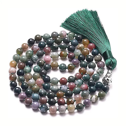 Geometric agate pendant necklace with colourful stone pattern and tassel detail on model