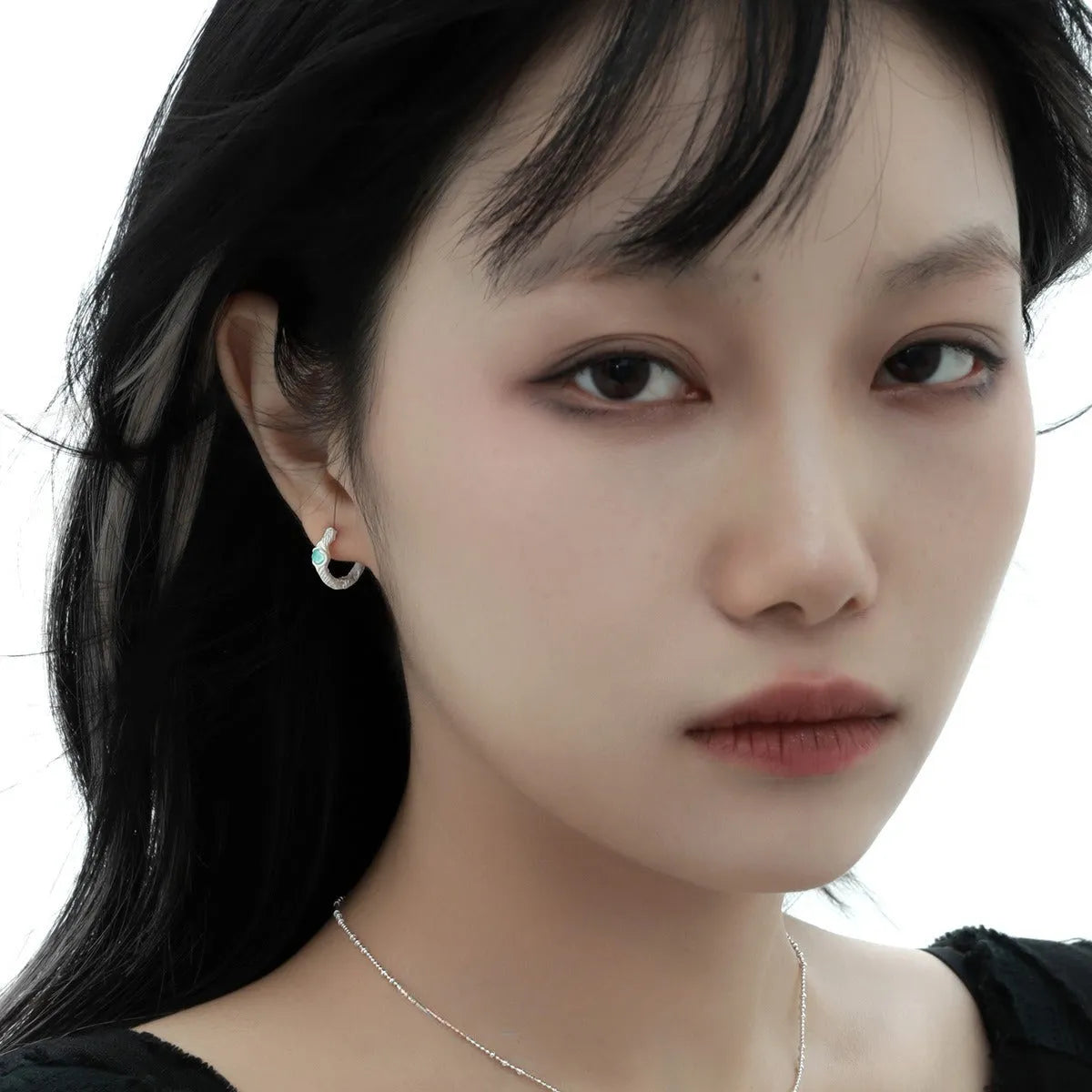 Geometric burnt silver ear clip for women, made from 925 sterling silver with a round design element.