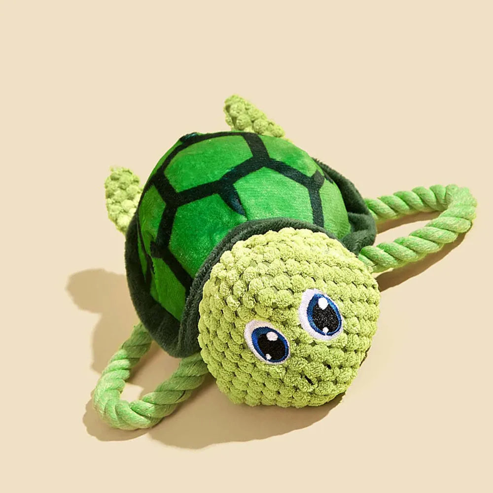 Turtle-shaped plush dog chew toy with knotted texture and squeaker inside