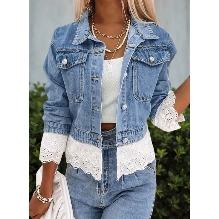 Blue women's denim jacket with lace stitching on the front, shown on a hanger.