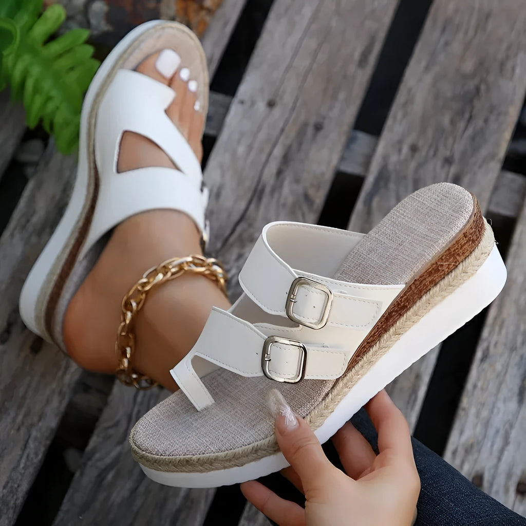 White woven patent leather women's wedge sandals with a peep toe and finger-fit strap design.