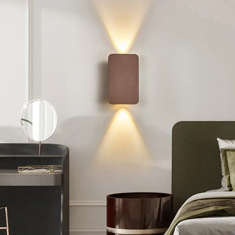 Minimalist modern LED wall lamp in black finish mounted on a wall.