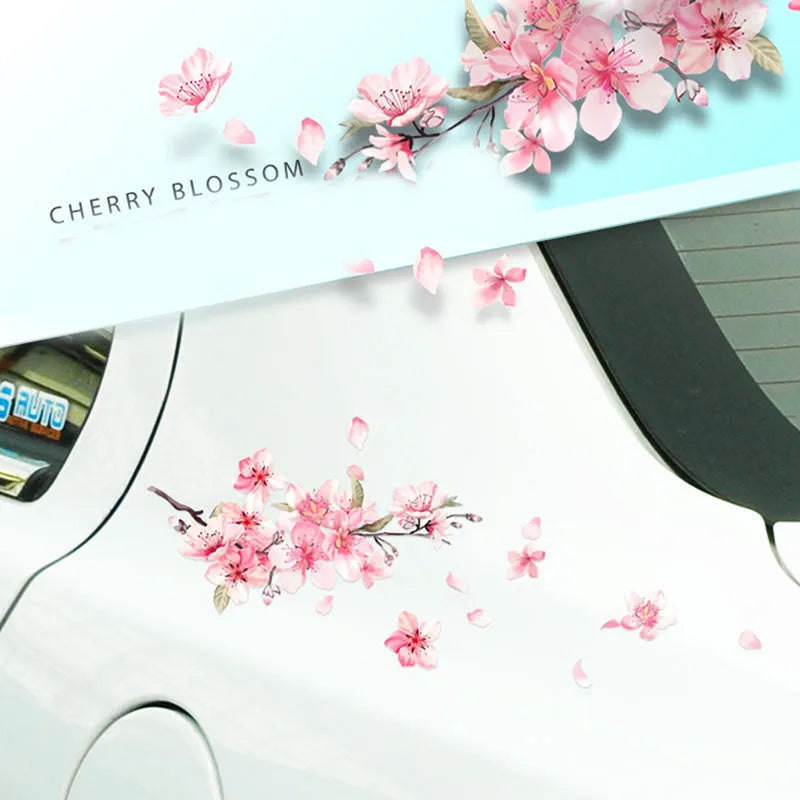 Close-up of a pink and white cherry blossom car sticker on a clear PVC backing.