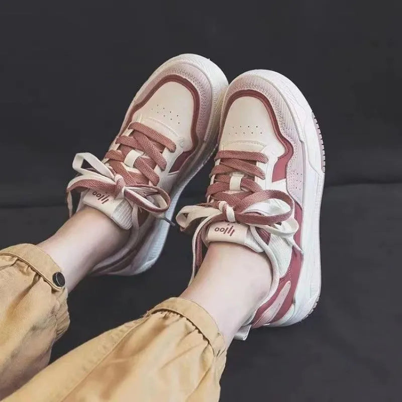 Pink and beige low top sneakers with rubber soles and height-increasing design