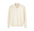 Man wearing a milky white pure wool polo sweater with a lapel collar in a loose fit.