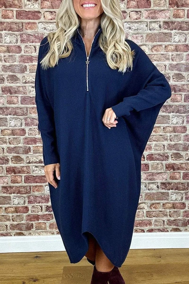 Dark green loose knitted women's dress with full front zipper and raglan sleeves on a hanger.
