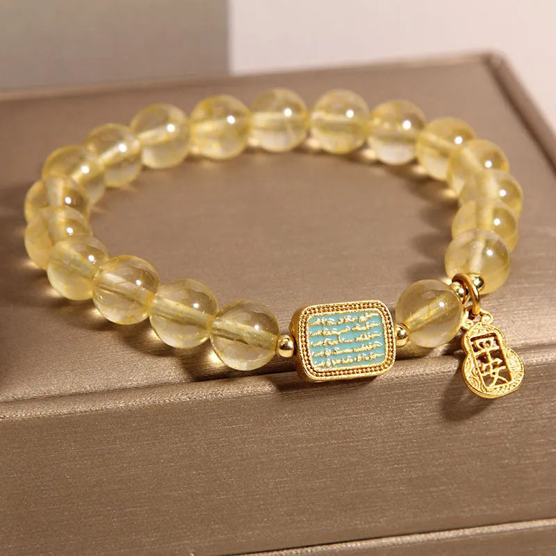 Women's yellow citrine crystal bracelet with rhinestone detailing on wrist