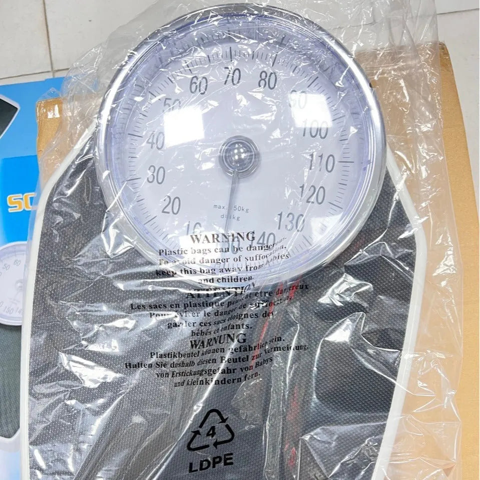 Black mechanical body weight scale with large dial display measuring 47x35x11cm