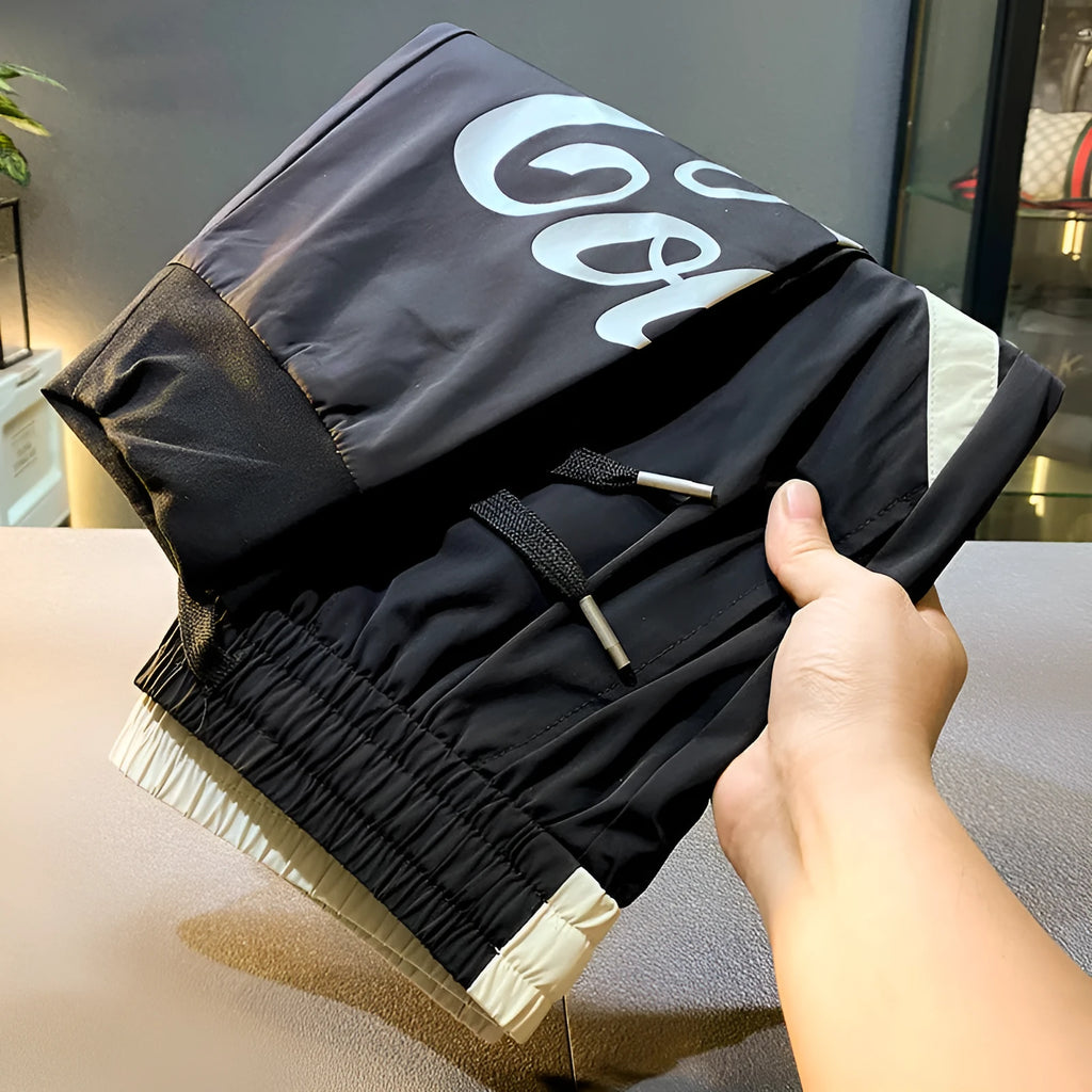Black men's cropped trousers with banded ankle made from ice silk and cotton fabric.
