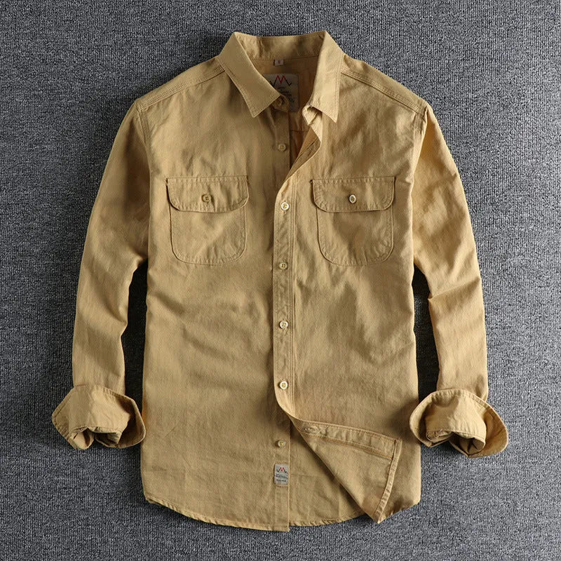 Men's light blue cotton long sleeve shirt in a cardigan style on a hanger.