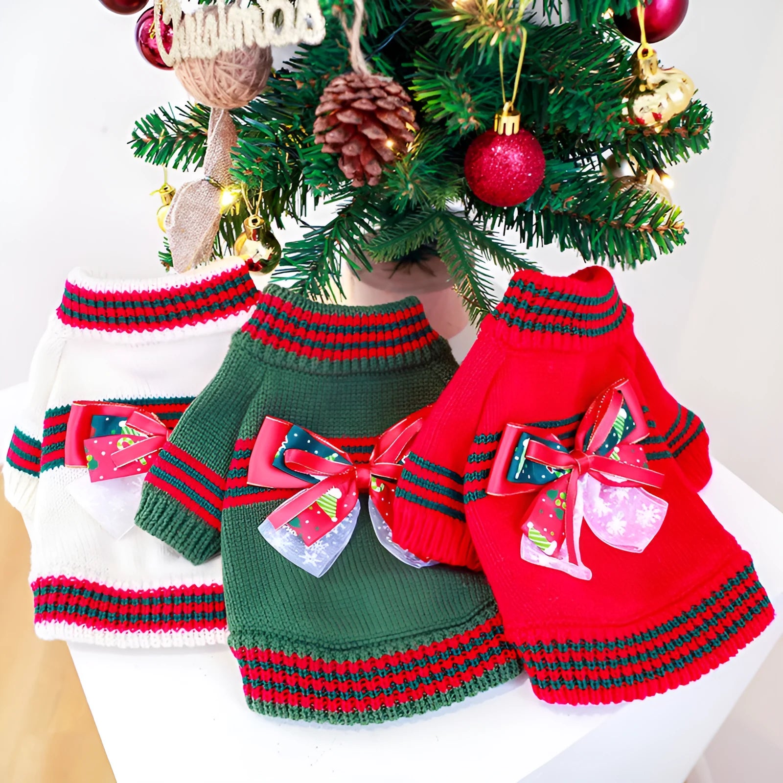 Red or green festive Christmas sweater for a dog on a white background.