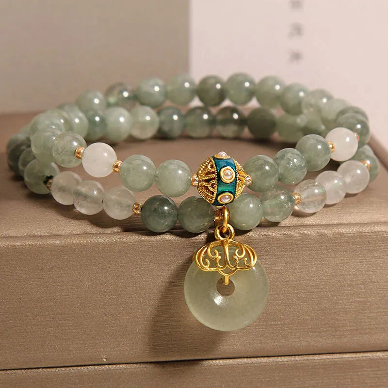 Women's green double-layer crystal bracelet with a peace buckle clasp and rhinestone details.