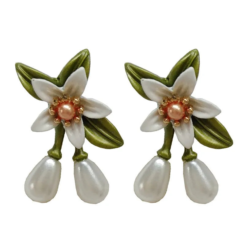 A pair of women's alloy flower earrings shown in two style options: sterling silver needle flowers and a coloured flower clip.