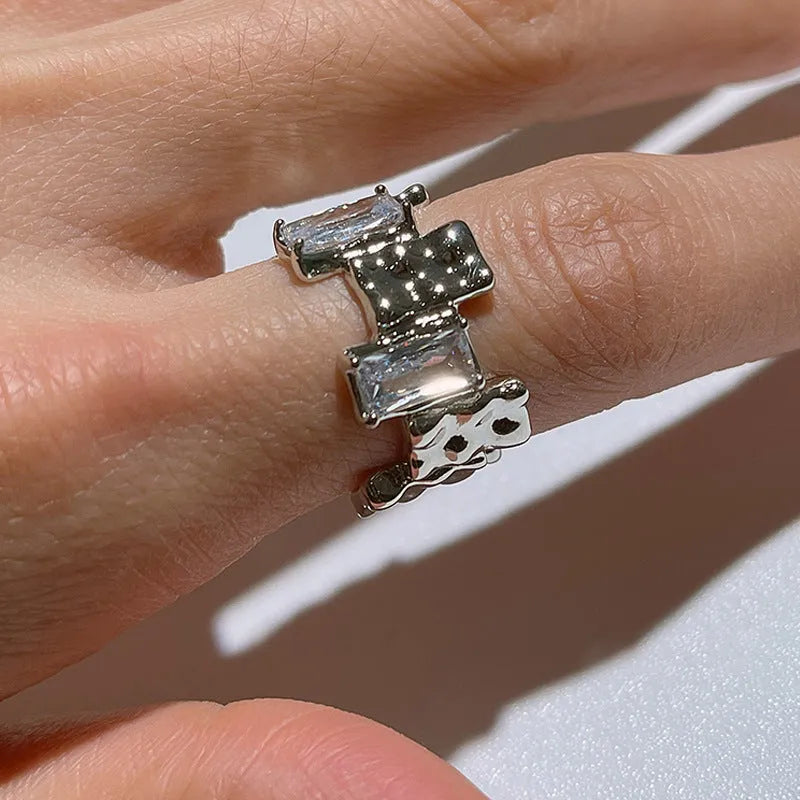 Silver geometric ring with cross zircon centre and open adjustable back