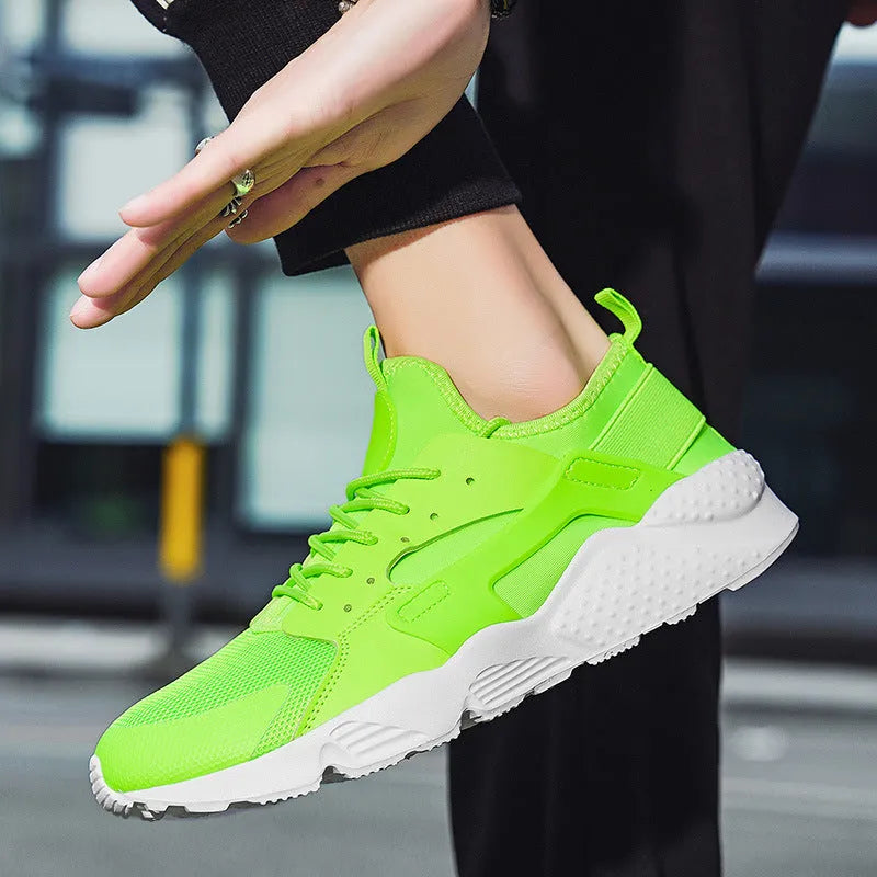 Men's low top lace-up casual trainers in fluorescent red with cross shoulder straps and mesh upper