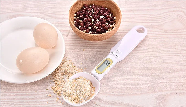 Black electronic measuring spoon scale showing digital display and spoon bowl for kitchen weighing