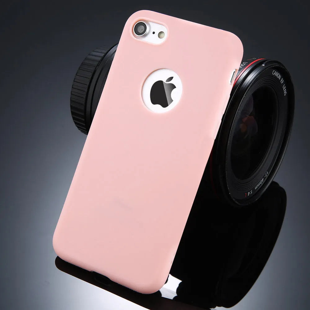 Plain soft silicone TPU phone case for iPhone in a candy colour on a table.