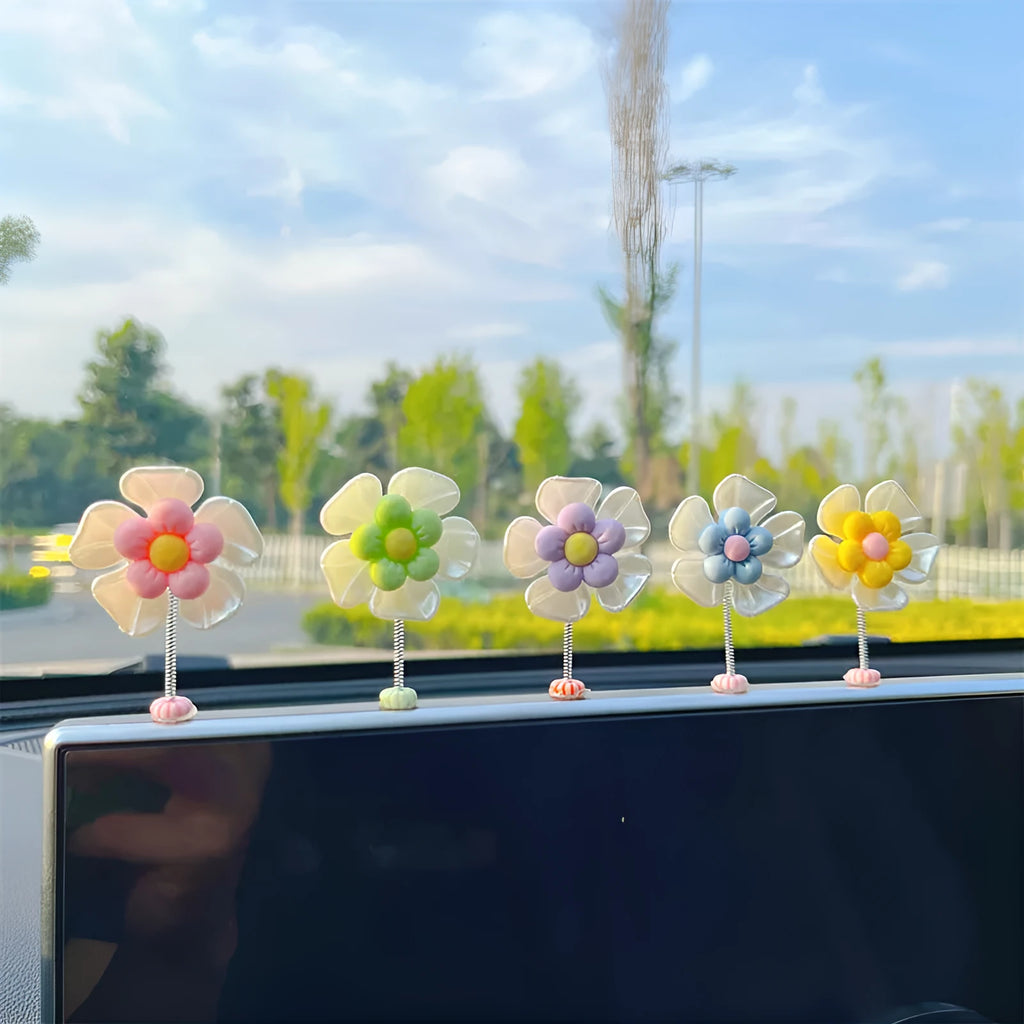 Small colourful plastic swing car decoration in blue, green, pink, purple, and yellow options.