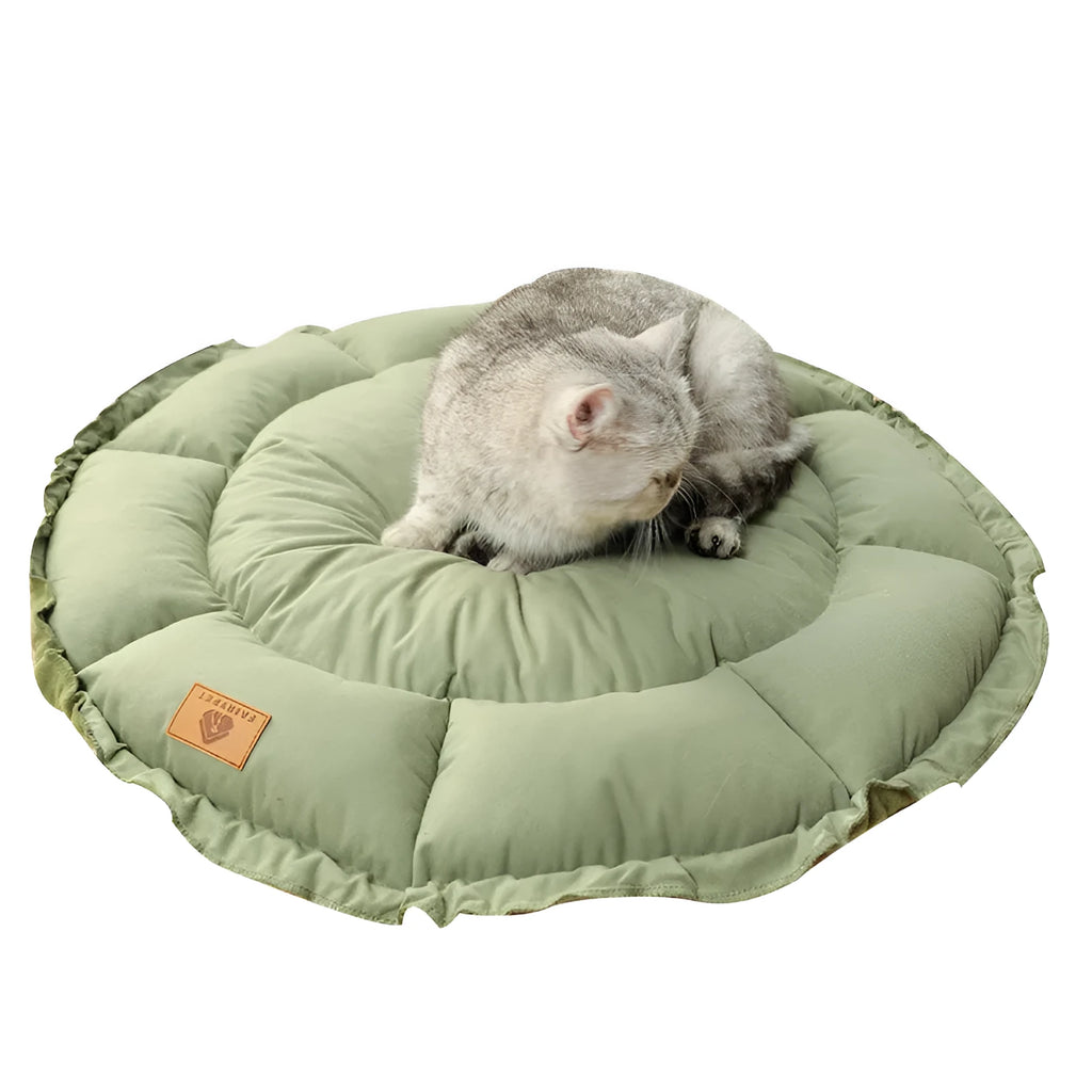 Grey reversible donut-shaped pet bed for cats and small dogs on a wooden floor.