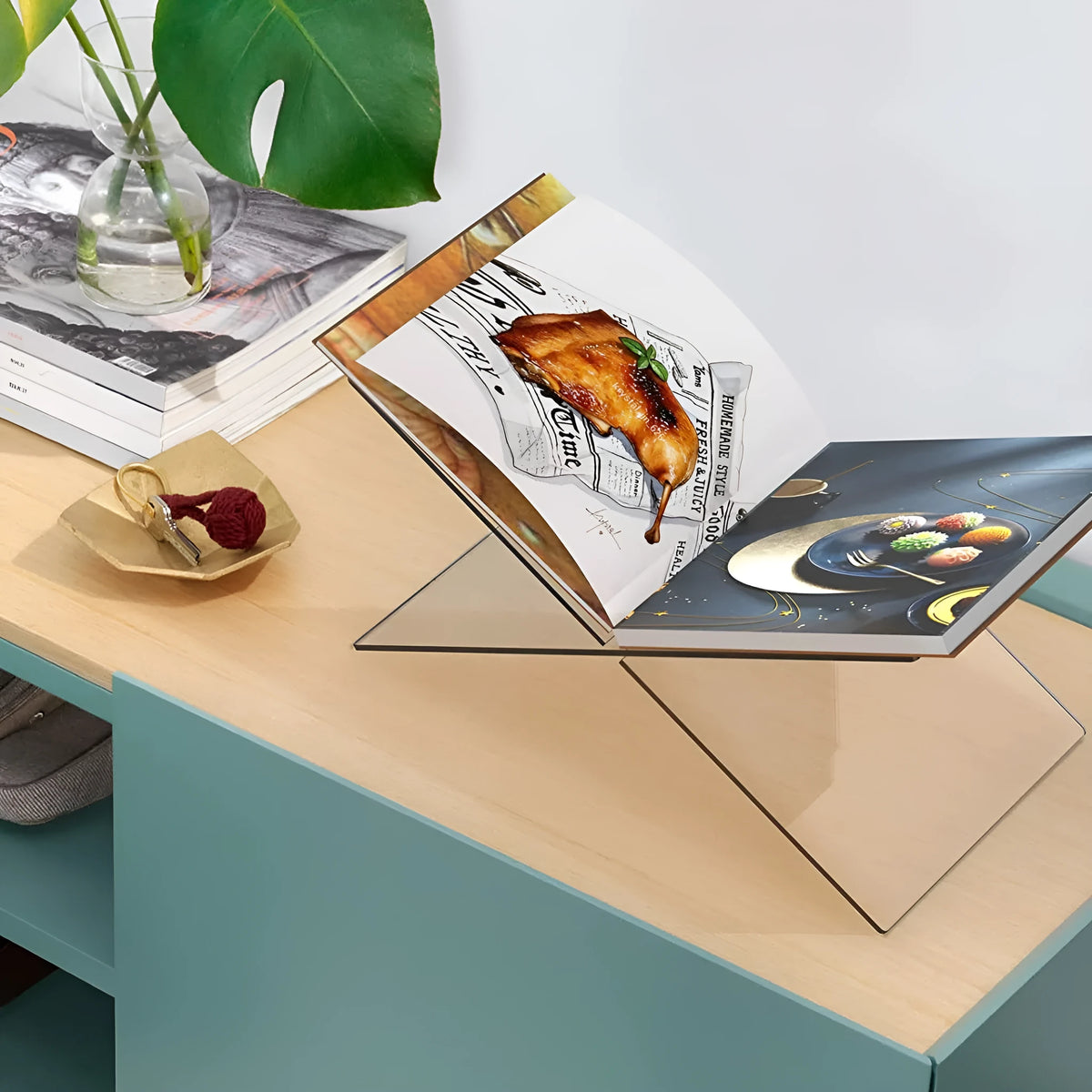 Clear acrylic X-type book reading rack displaying books on desktop