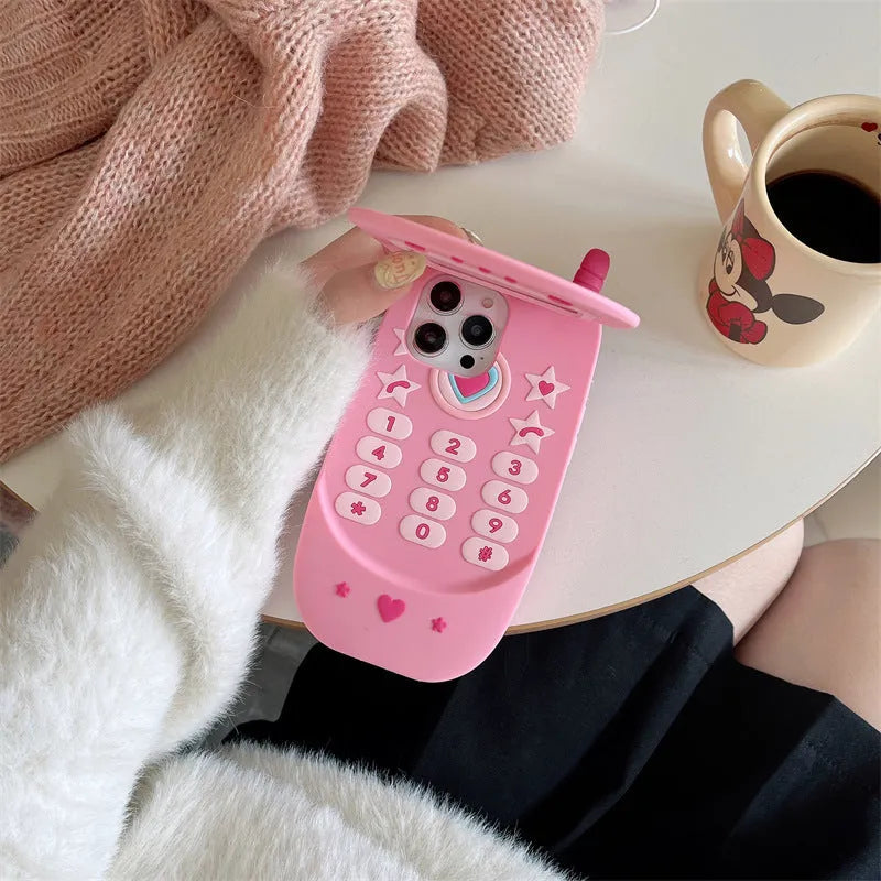 Light pink silicone flip phone case with a built-in mirror, open and showing iPhone model compatibility.