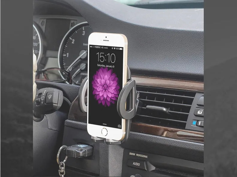 Black plastic car air conditioning vent mobile phone holder showing adjustable clamp for universal device mounting.