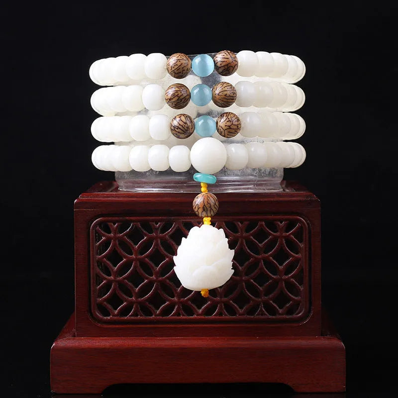 White jade Bodhi bead long bracelet with 6x8mm beads in various styles including cloisonne and tassel designs.