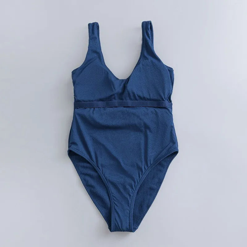 Navy blue women's one-piece slimming swimsuit with triangle design and chest pad.