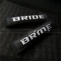 Pair of black car seat belt shoulder pads made from cotton sponge cloth, showing embroidery detail.