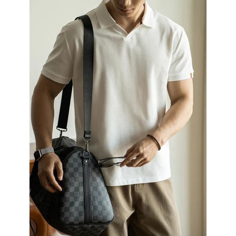 Man's American-style blue cotton blend short-sleeved polo shirt on a hanger.