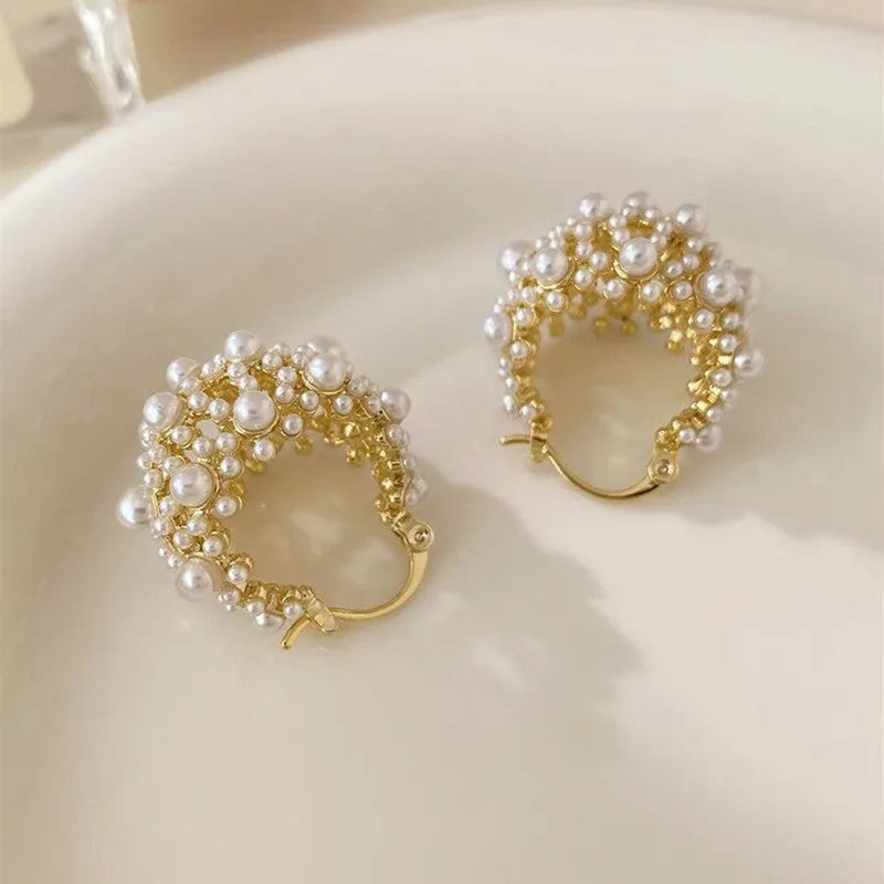 Gold copper flower basket earrings with small rice-shaped beads and pearl inlay detail