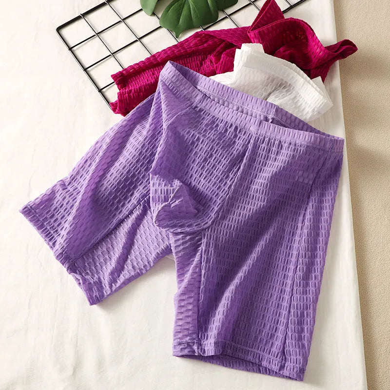 Men's solid colour lace boxer shorts with a lengthened hip lifting design on a size chart.