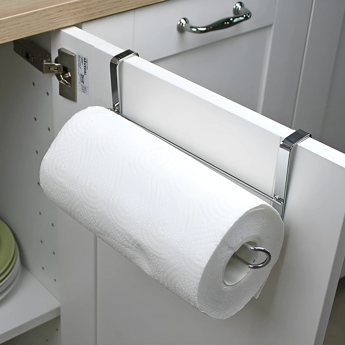 Silver stainless steel paper towel rack mounted on a cabinet door.