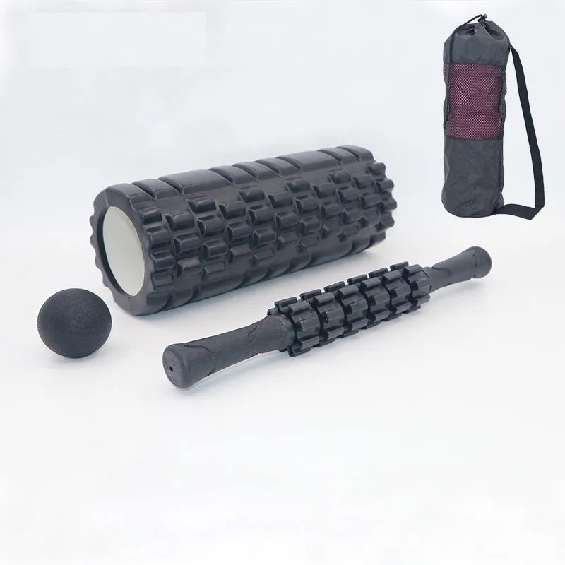 Black foam fitness roller with six-piece gear design, 33cm length, for massage and recovery.