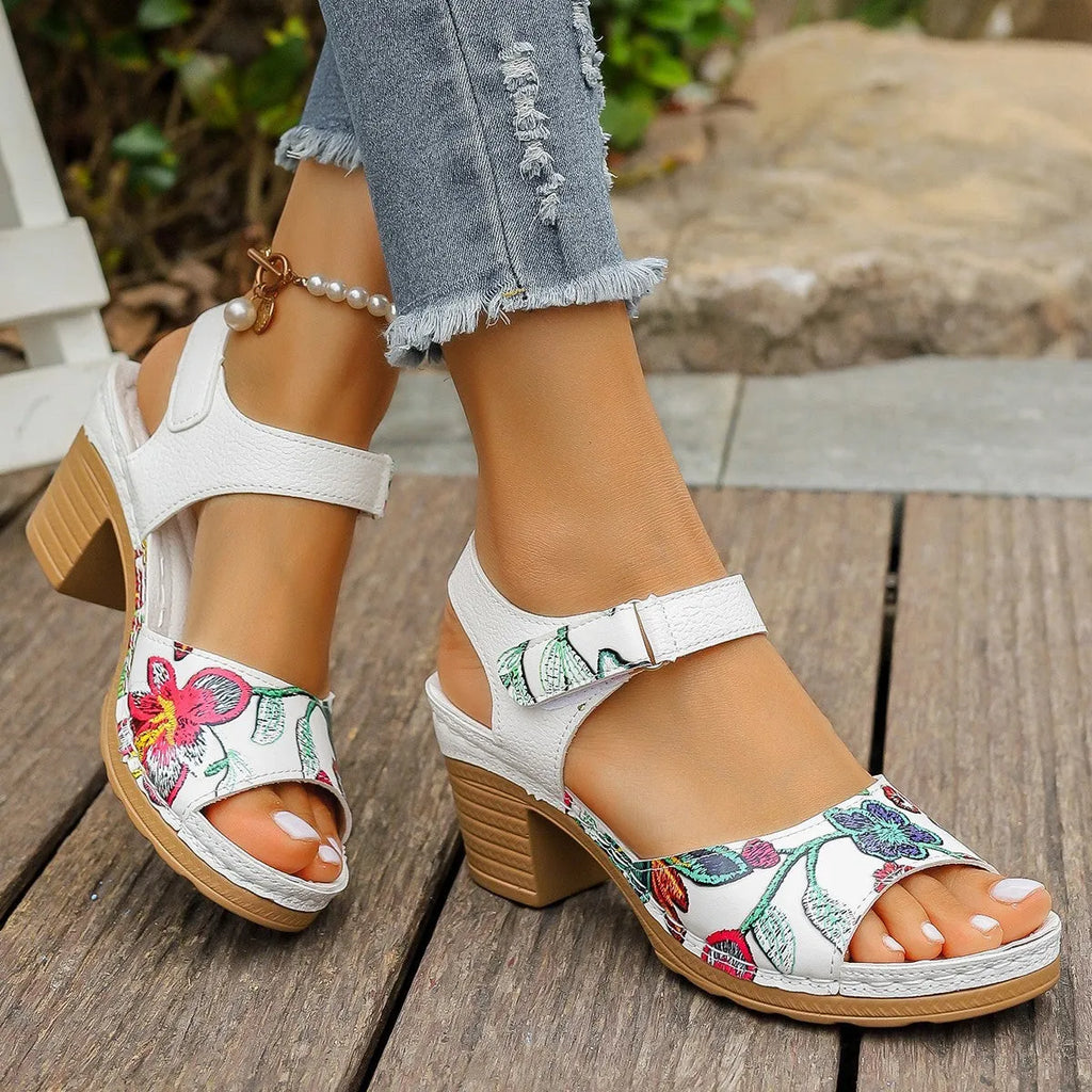 White women's high heel sandals with a velcro buckle strap and rubber sole.