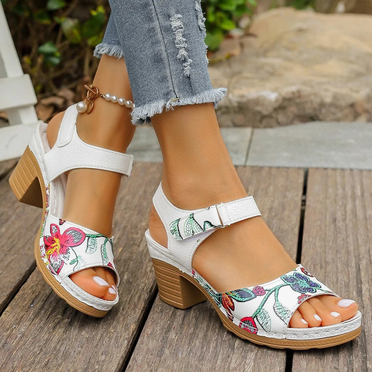 White women's high heel sandals with a velcro buckle strap and rubber sole.
