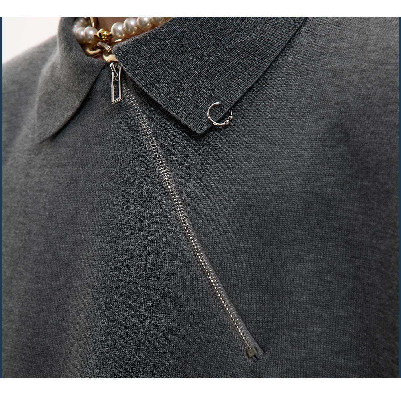 Man modelling a slim-fit black knitted polo shirt with an angled diagonal zipper and a lapel collar.