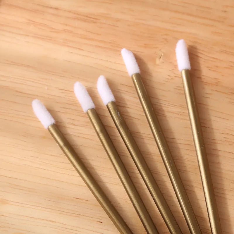 Disposable lip brushes with flocked tips and black handles in multiple colours