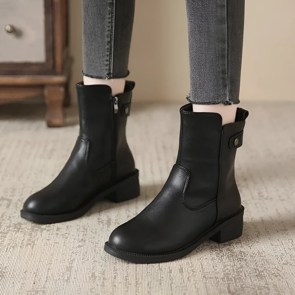 Black women's low heel ankle boots with a side zip and round toe.
