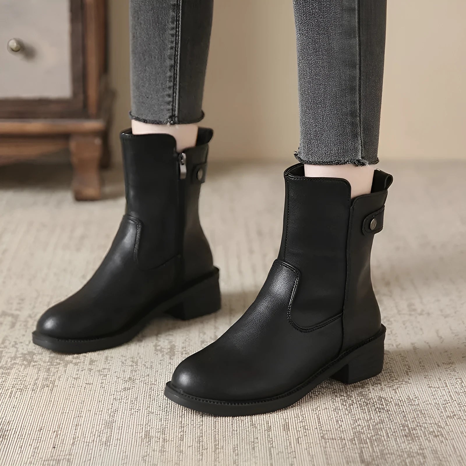 Black women's low heel ankle boots with a side zip and round toe.