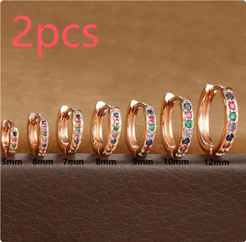 Set of three pairs of round zircon stud earrings showing gold colour, rose gold colour, and silver colour finishes.