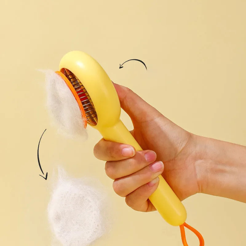 Small yellow duck-shaped pet comb with detachable needle teeth for cat and dog grooming.