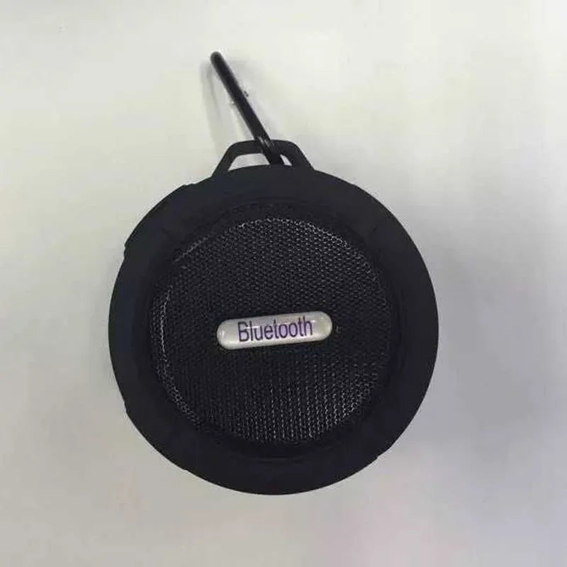 Portable waterproof Bluetooth speaker in multiple colours with a built-in carabiner clip for bags.