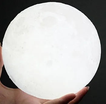 3D printed moon light lamp on wooden stand with detailed lunar surface, showing touch ring at base.