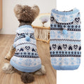 Colourful knitted dog sweater with snowflake and love heart patterns on a striped background.