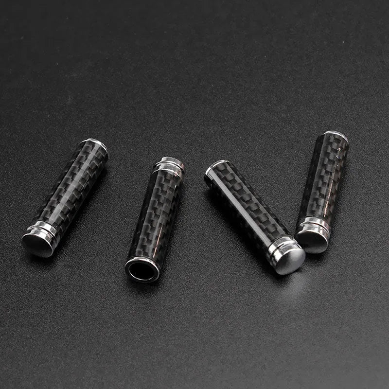 Set of four carbon fibre car door handle covers for universal fit installation.