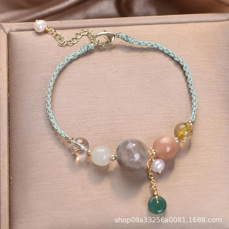 Hand-woven crystal and sequin bracelet with metal buckle clasp in red, blue, or green.